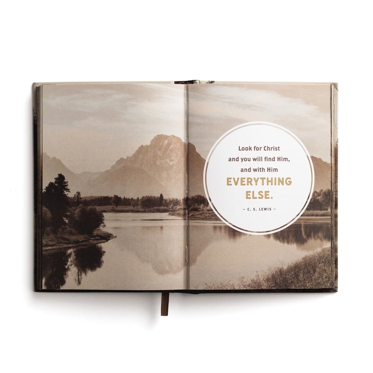 Open book with a scenic landscape and a quote on a white background