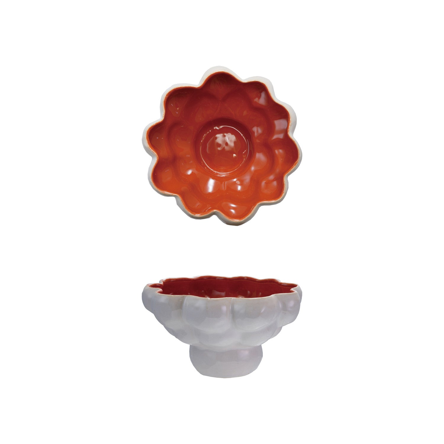 Two ceramic bowls, one orange and one white, on a white background