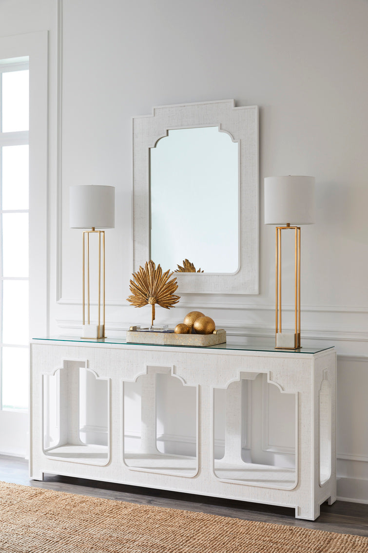 White console table with decorative items against a light gray wall.
