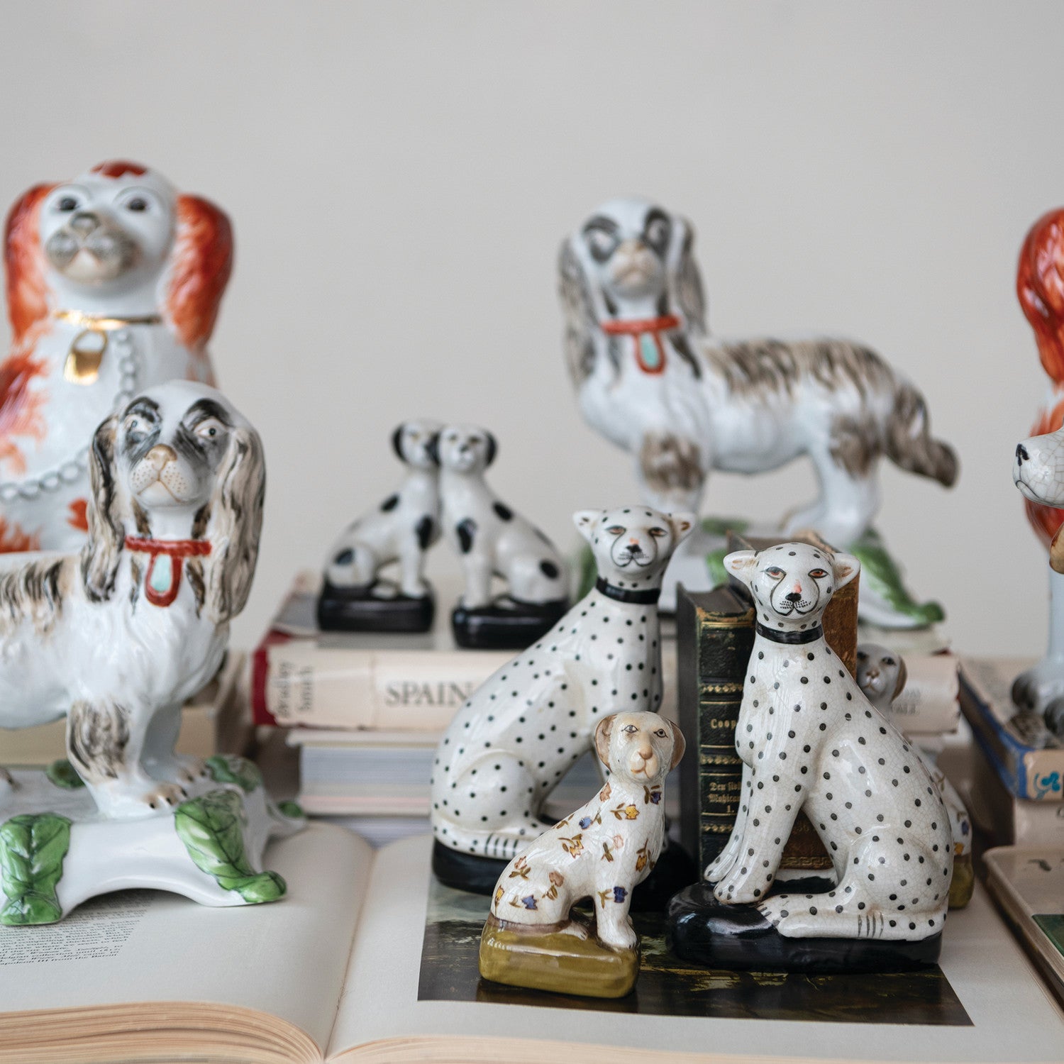 Collection of ceramic dog figurines on an open book