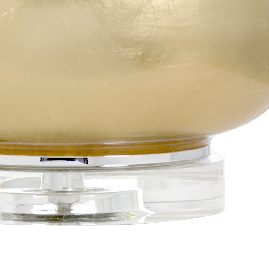 Close-up of a glass lamp with a gold interior on a white background