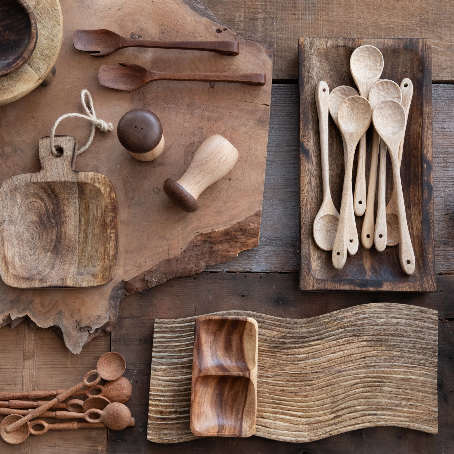 Collection of wooden kitchen utensils on a wooden surface