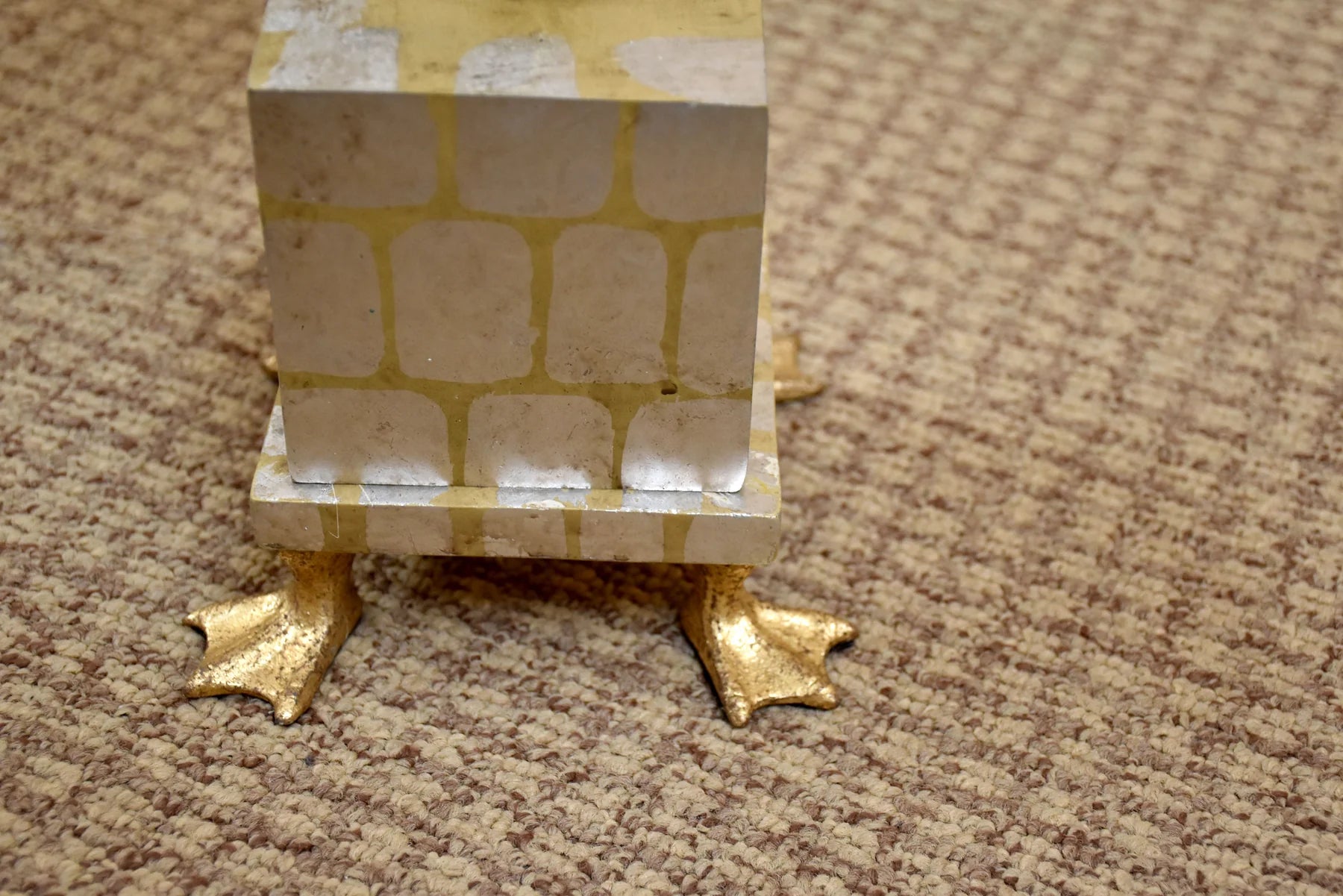 Decorative Lamp with gold feet on a beige carpet