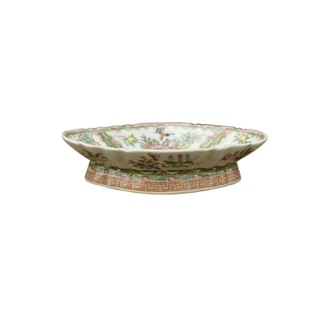 Decorative ceramic dish with floral patterns on a white background