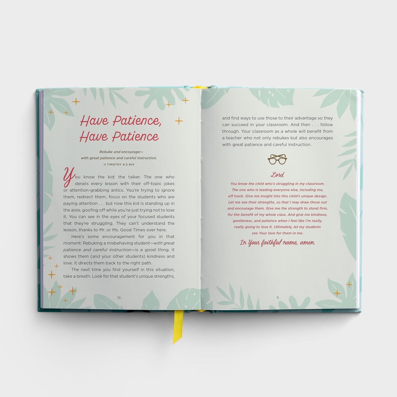 Open book with green leafy design on a white background