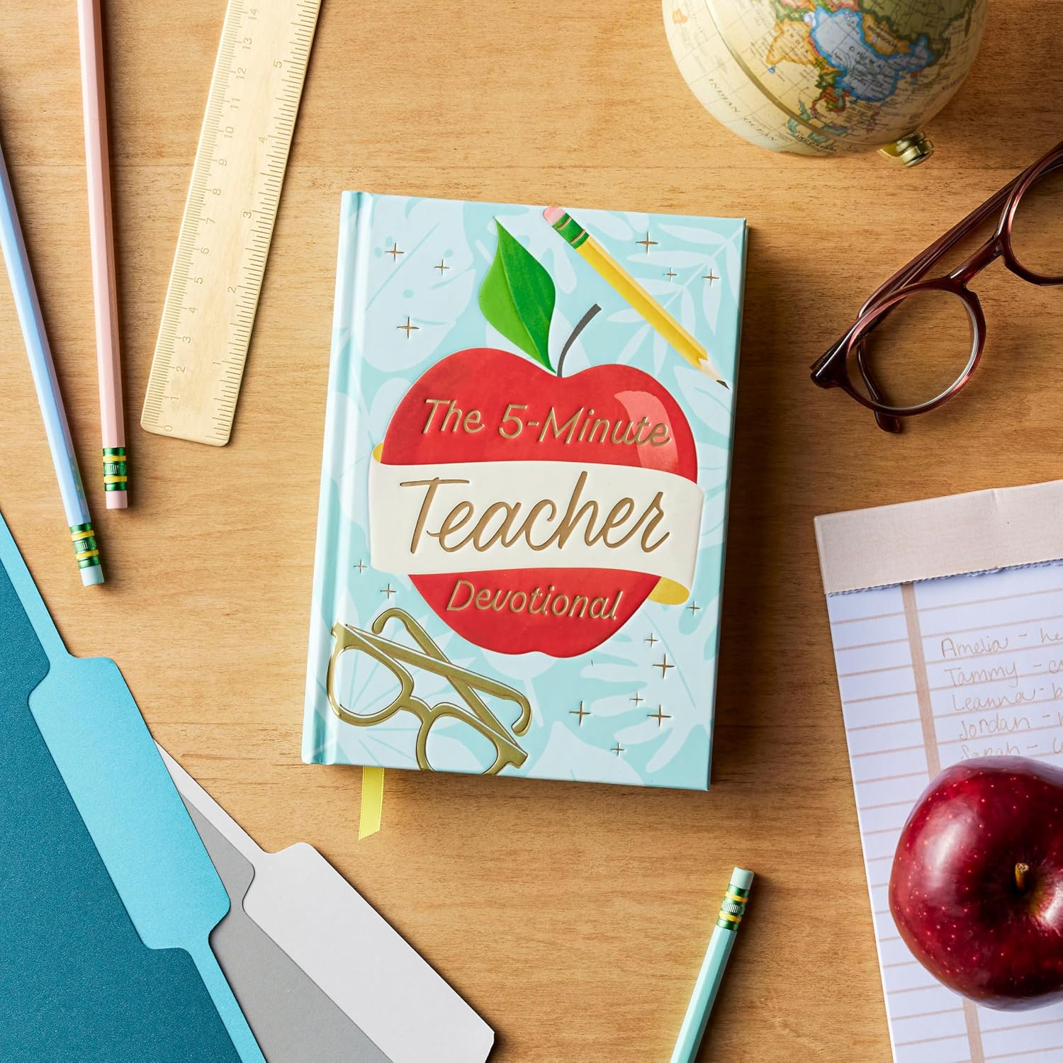 Book titled 'The 5-Minute Teacher Devotional' on a desk with educational items