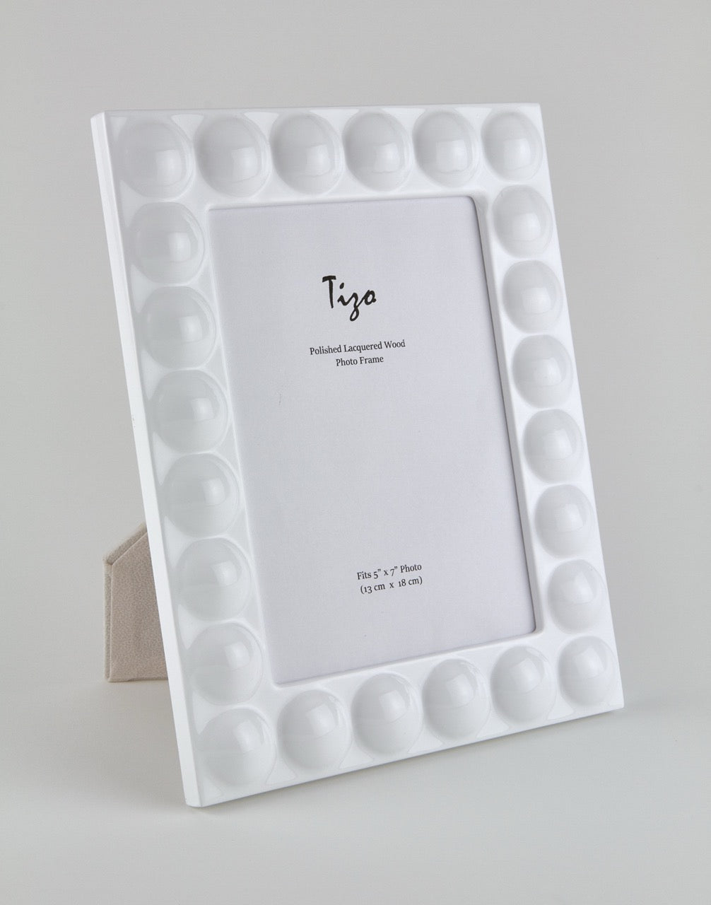 White photo frame with circular patterns on a gray background