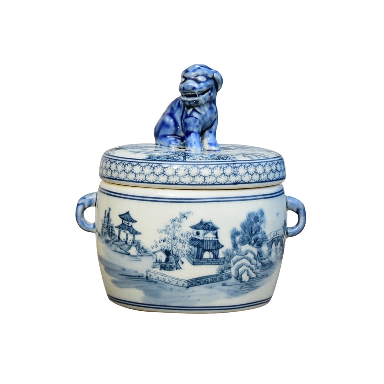 Blue and white ceramic jar with lid featuring a lion dog figurine on a white background