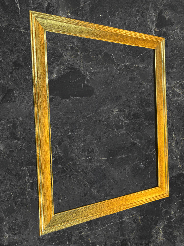 Gold picture frame on a black marble surface
