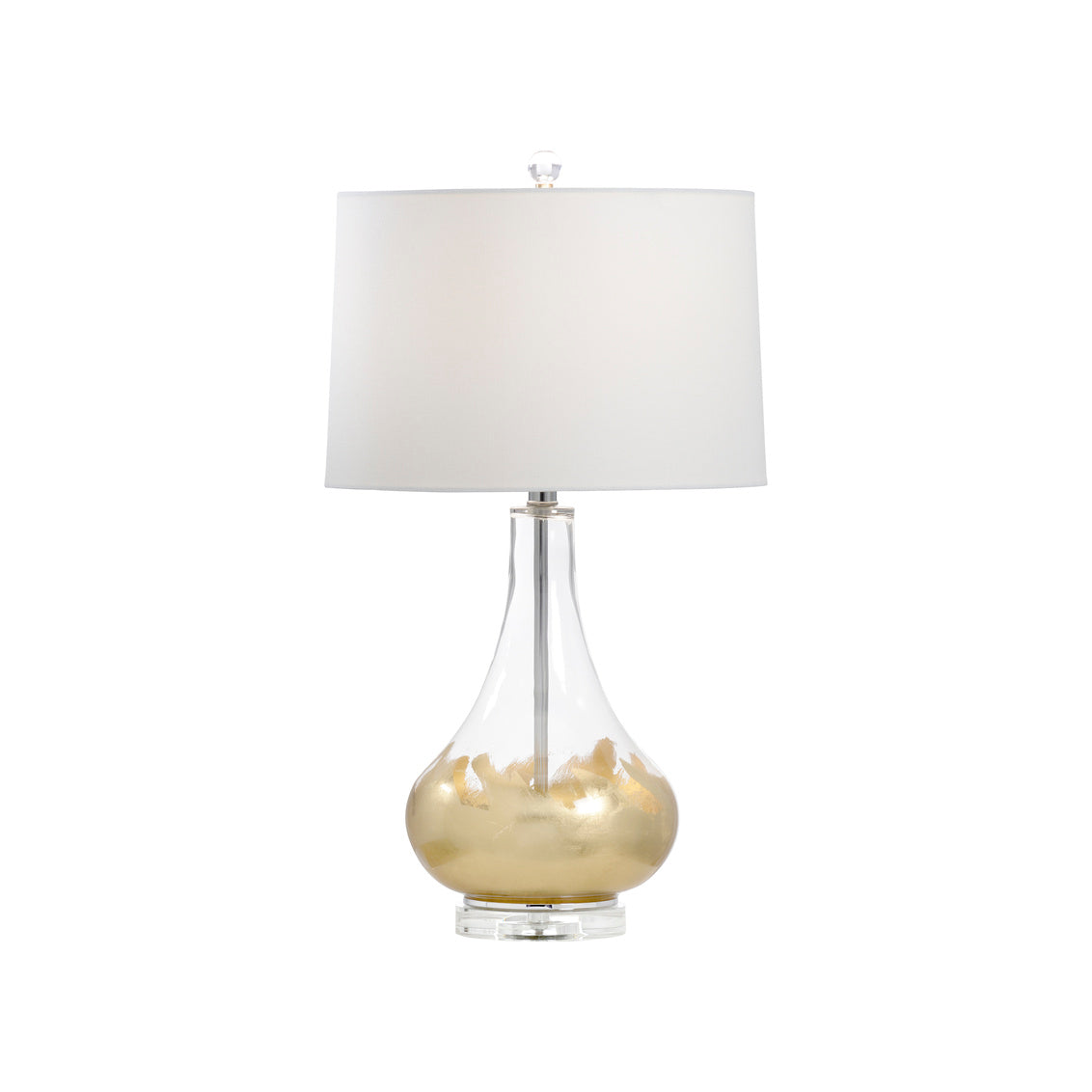 Table lamp with clear glass base and white shade on a white background