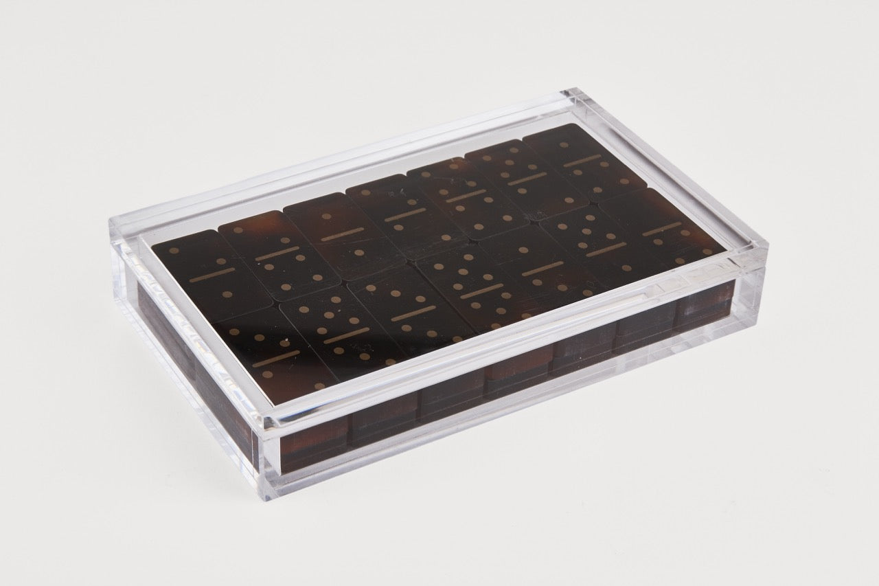 Clear plastic container with dark brown items on a light gray background