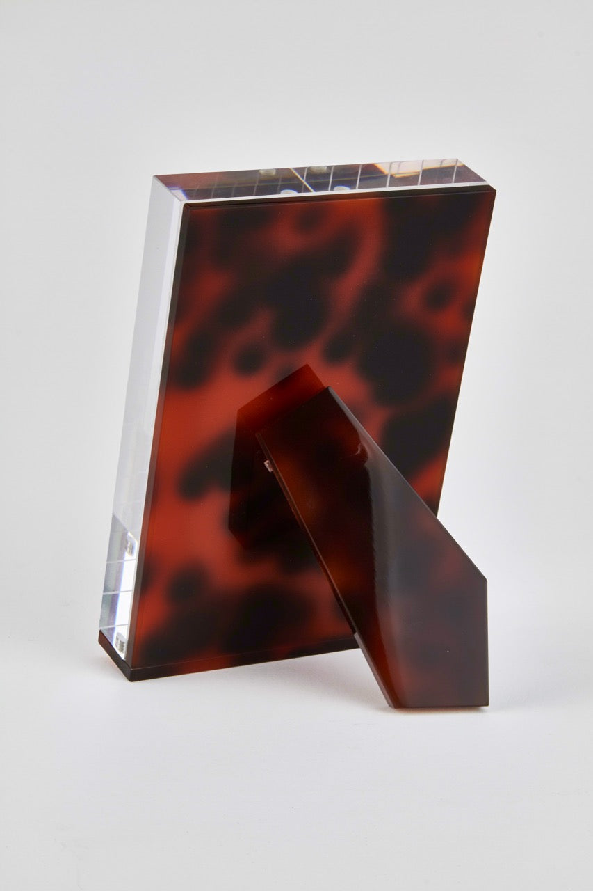 Tortoiseshell and clear rectangular object on a white background