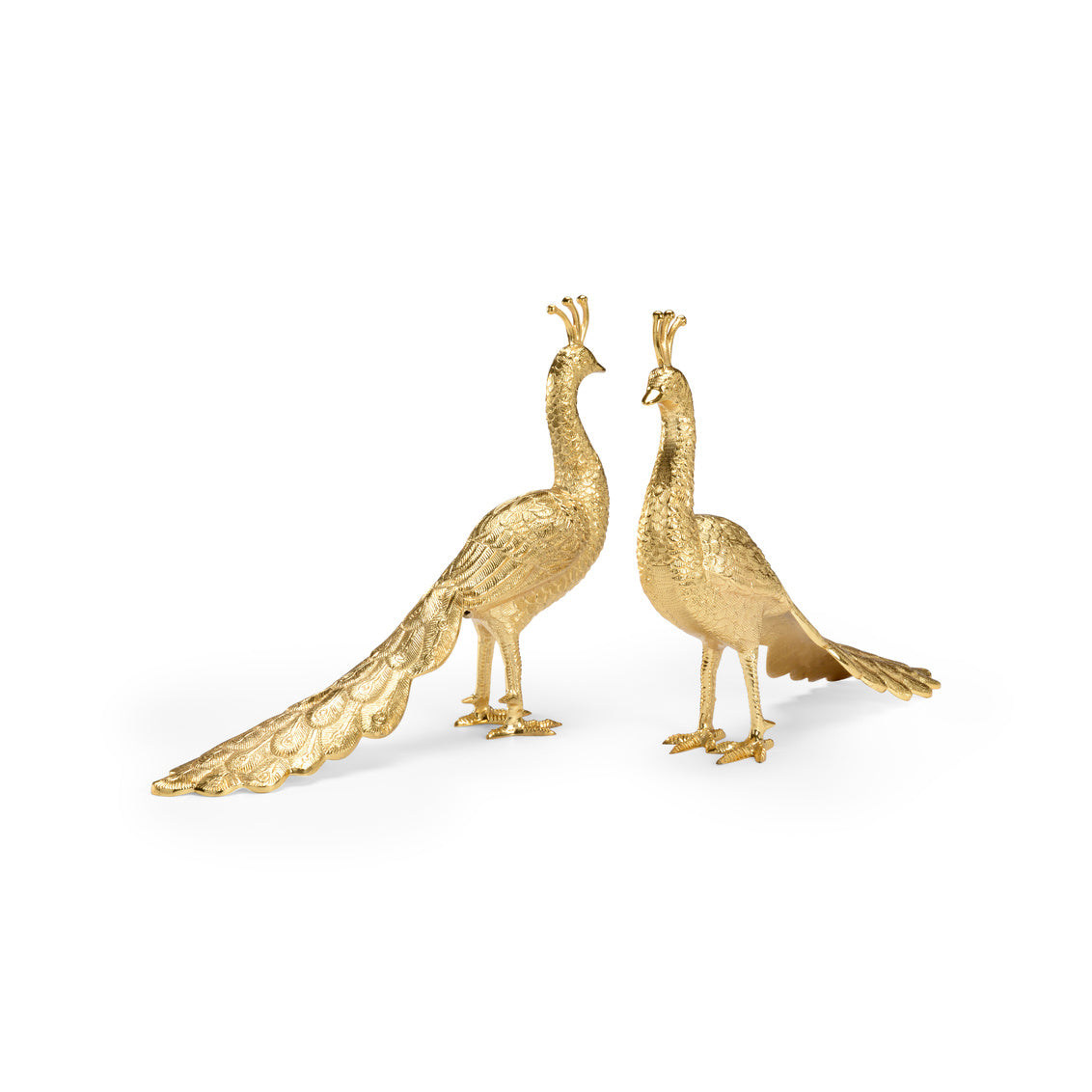 Two gold peacock statues on a white background